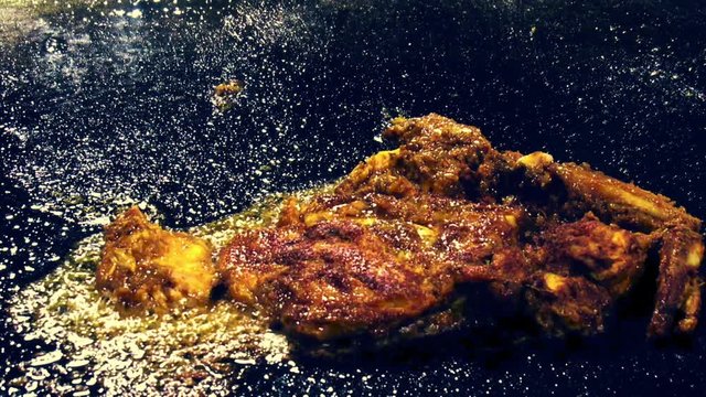 Famous Indian dish i.e. Tangdi. A fired chicken leg with spices in it.Fried on black colored large fryer. Served in the iftar also.