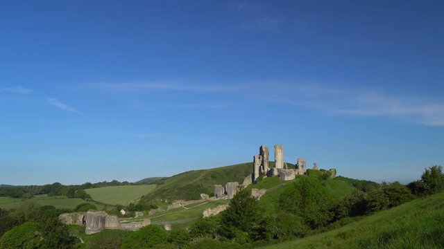 Slow panning shot of Corfe Castle in early morning light, Isle of Purbeck, Dorset, England.