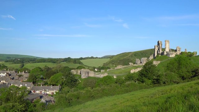 Slow panning shot of Corfe village and castle early morning, Isle of Purbeck, Dorset, England.