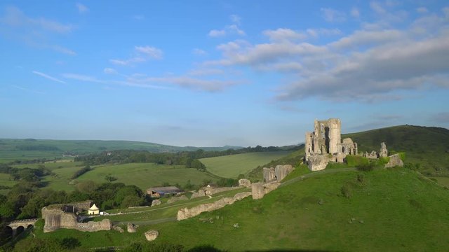 Slow panning shot of Corfe Castle in early morning light, Isle of Purbeck, Dorset, England.