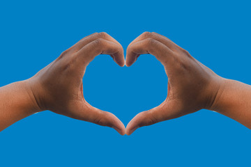 Obraz premium Man's hands make a heart shape. With a sky background