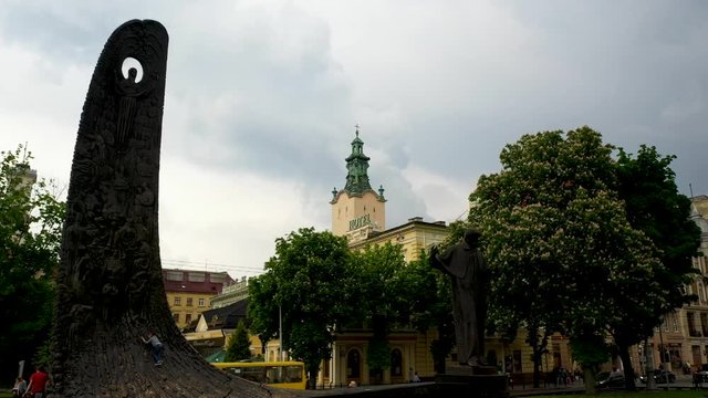 Flying near the town hall in the city of Lviv with rainy weather with clouds