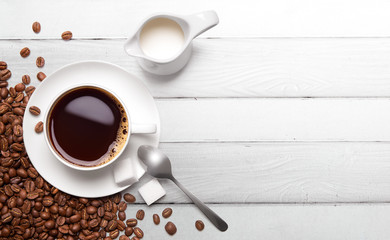 Roasted coffee beans and cup of black coffee