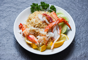 Fried Rice crab seafood - Healthy food fried rice with Crab legs with egg lemon and cucumber on white plate
