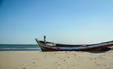 single wood boat lying on the beach