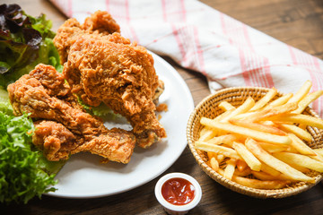 french fries basket ketchup on wooden dining table background and fried chicken crispy and salad lettuce