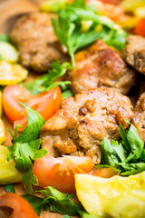 Grilled meat with vegetables on the wooden plate. Selective focus. Shallow depth of field.