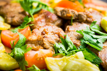 Grilled meat with vegetables on the wooden plate. Selective focus. Shallow depth of field.