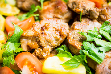 Grilled meat with vegetables on the wooden plate. Selective focus. Shallow depth of field.