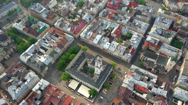 Flying near the town hall in the city of Lviv with rainy weather with clouds