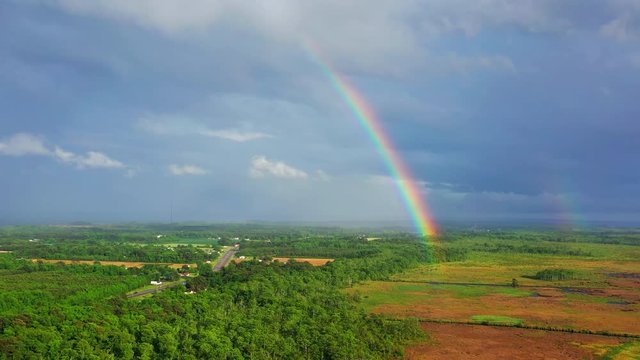 Aerial drone panning past rainbow.