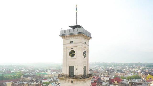 Flying near the town hall in the city of Lviv with rainy weather with clouds