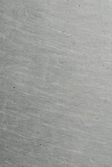 A scratched shiny metal surface.