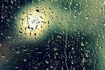 Water drops on glass during a rain close up. Natural background