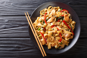 This stir-fry of wide rice noodles with chicken and fresh basil in a spicy, sweet and tangy sauce ...
