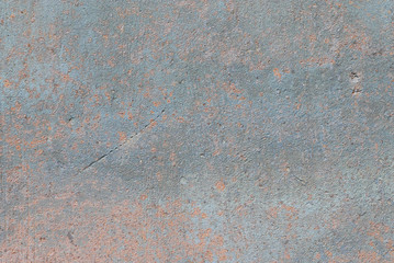 Rough corroded gray metal with some red rust.