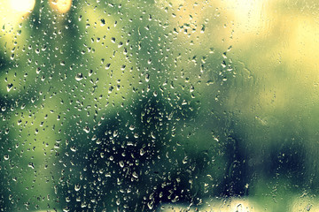 Water drops on glass during a rain close up. Natural background