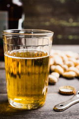Glass of beer on the dark rustic wooden background. Selective focus. Shallow depth of field.