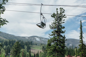 Empty chairs of ski lift at summer time