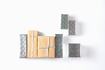 composition of gift boxes. packing silver and craft paper. holiday minimalistic concept. flat lay, top view