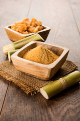 Organic Gur or Jggery Powder is unrefined sugar obtained from concentrated sugarcane juice. served in a bowl. selective focus