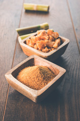 Organic Gur or Jggery Powder is unrefined sugar obtained from concentrated sugarcane juice. served in a bowl. selective focus