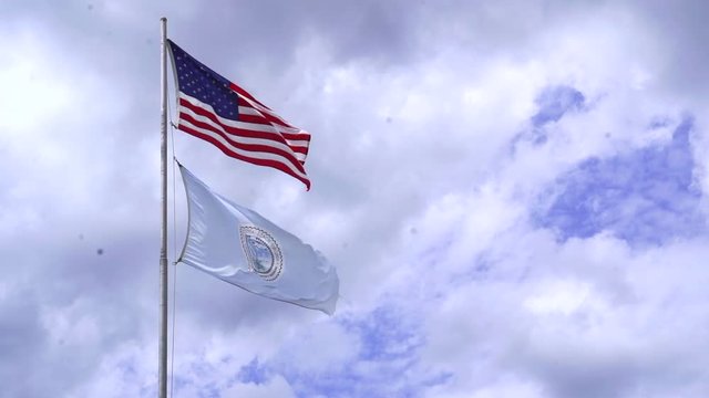 American flag and Virginia Beach flag in the wind