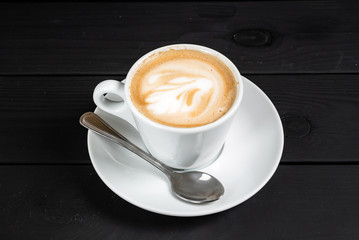 cup of cappuccino on the black background