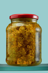 Glass jar with various tinctures in isolate