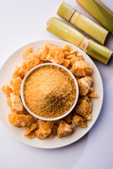 Organic Gur or Jggery Powder is unrefined sugar obtained from concentrated sugarcane juice. served in a bowl. selective focus