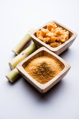 Organic Gur or Jggery Powder is unrefined sugar obtained from concentrated sugarcane juice. served in a bowl. selective focus