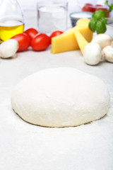 Raw dough preparation of pizza with ingredient