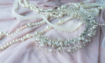 Wedding background with pearls and hair accessories on pink background