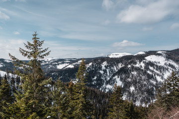 Winter mountain landscape with white snow and blue sky