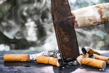 The World No Tobacco Day falls on May 31 of every year.Smoke cigarettes were smashed, destroyed by an iron hammer.Smoking stop concept Eliminate smoking.vintage tone.
