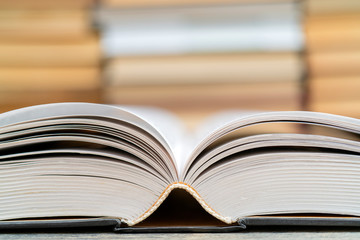 Opened thick book. Symbol of wisdom, knowledge and learning.