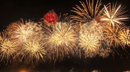 Gold color Holiday red firework with copy space for New Year celebration, Abstract holiday background.	