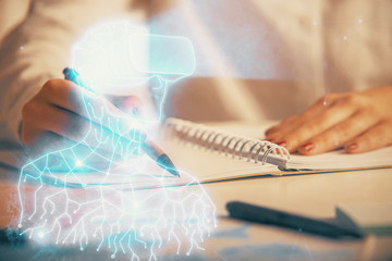 Fototapeta premium AR hologram over hands taking notes background. Concept of augmented reality. Double exposure
