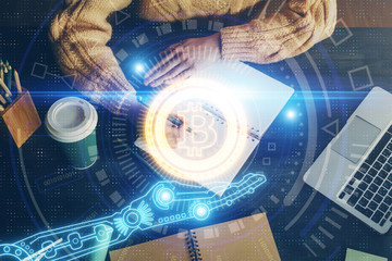 Cryptocurrency hologram over hands taking notes background. Concept of blockchain. Multi exposure