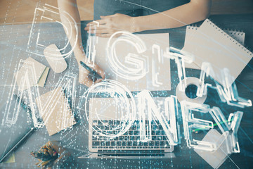 Cryptocurrency hologram over hands taking notes background. Concept of blockchain. Multi exposure