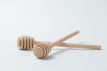 Wooden sticks for honey on a white background	