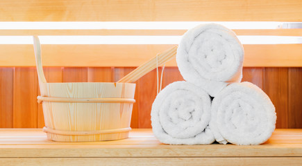 Traditional Finnish wooden sauna for relaxation with bucket of water and set of  towels