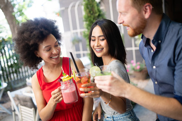 Young friends having a great time together. Group of people talking and smiling.