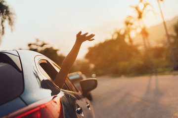 Fototapeta Hatchback Car travel driving road trip of woman summer vacation in blue car at sunset,Girls happy traveling enjoy holidays and relaxation with friends together get the atmosphere and go to destination obraz