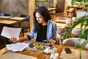 Lunch matters. Businesswoman having lunch in company's restaurant. Cozy interior