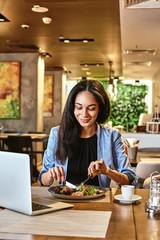 Start with a cry, end with a smile. Businesswoman having lunch in company's restaurant. Cozy...