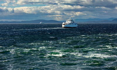 The ferry makes a regular flight from Vancouver to Nanaimo, windy day, stormy sky, stormy sea, blue water with a green tint
