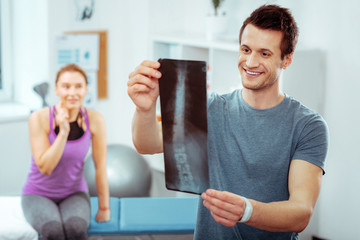 Nice handsome doctor holding an X ray image