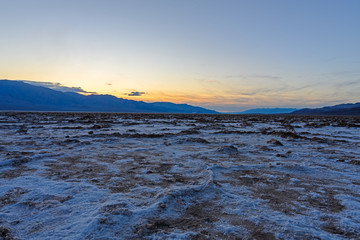 Death Valley, California / USA - May 24, 2019: Badwater Baseline in Death Valley California. Salt landscape in a National Park at sunset.