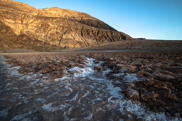 Death Valley, California / USA - May 24, 2019: Badwater Baseline in Death Valley California. Salt landscape in a National Park at sunset.